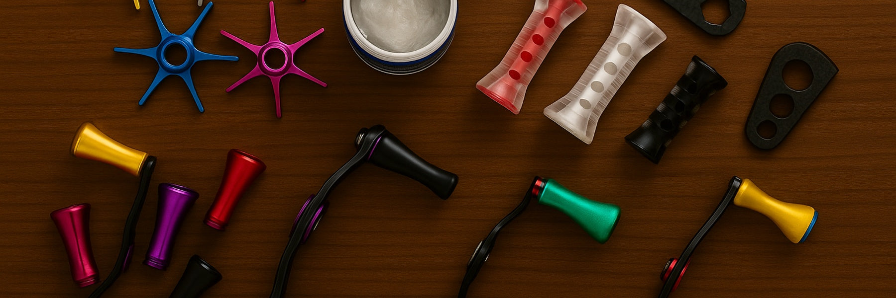 Assorted fishing reel parts and accessories including handles, knobs, tools, and spanners arranged on a timber background