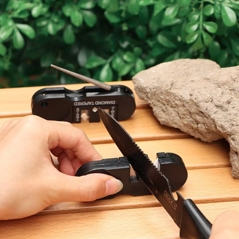 4-in-1 pocket knife sharpener sharpening a fishing knife blade on outdoor table