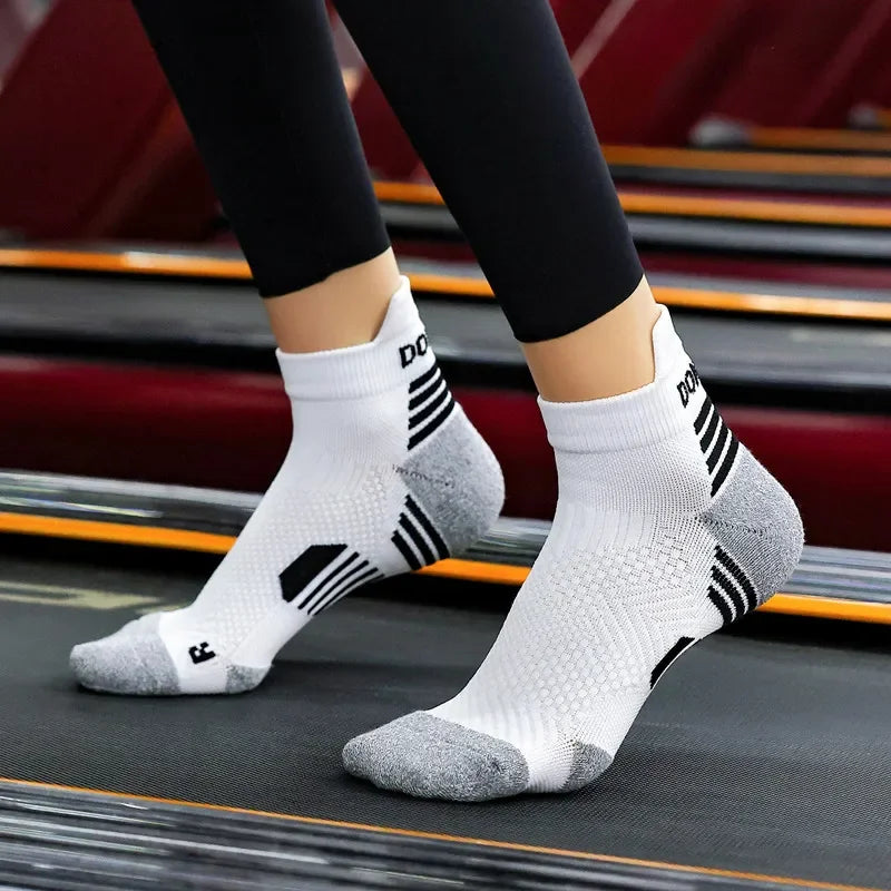 White and grey athletic ankle socks worn on treadmill