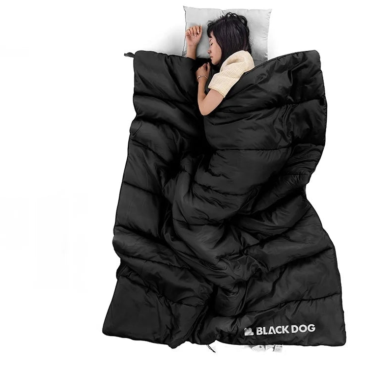 Person lying inside black envelope style sleeping bag