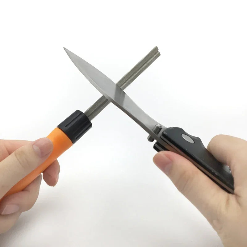 Person sharpening a fishing knife using compact handheld sharpener