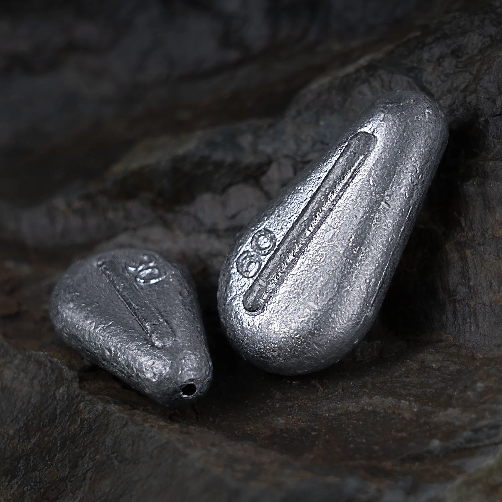 Close up of flat no roll slip sinker showing textured lead finish