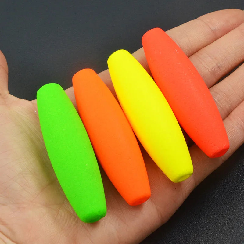Bright foam peg fishing floats held in hand showing size and colour options