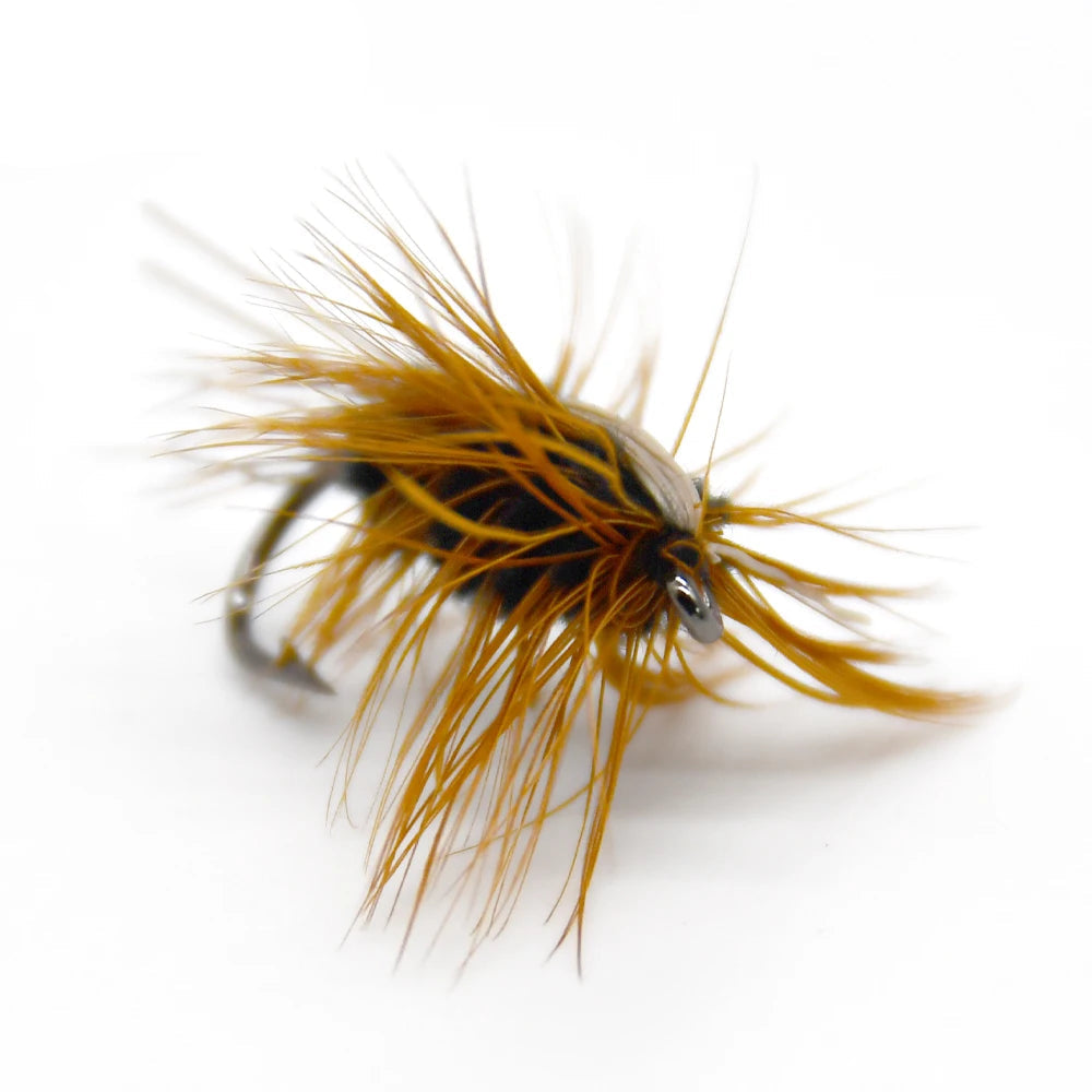 Gold head worm style trout fly on light background
