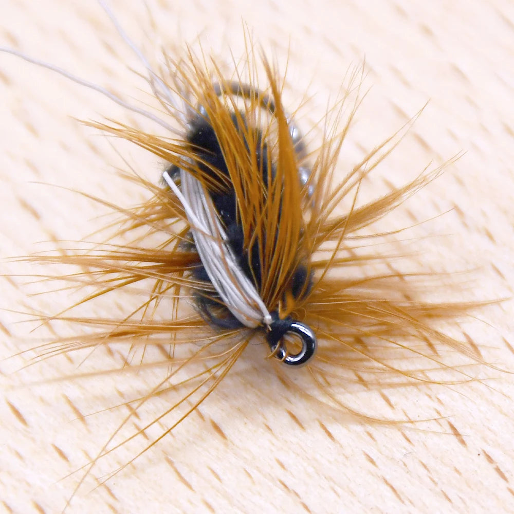 Gold head worm style trout fly viewed from above