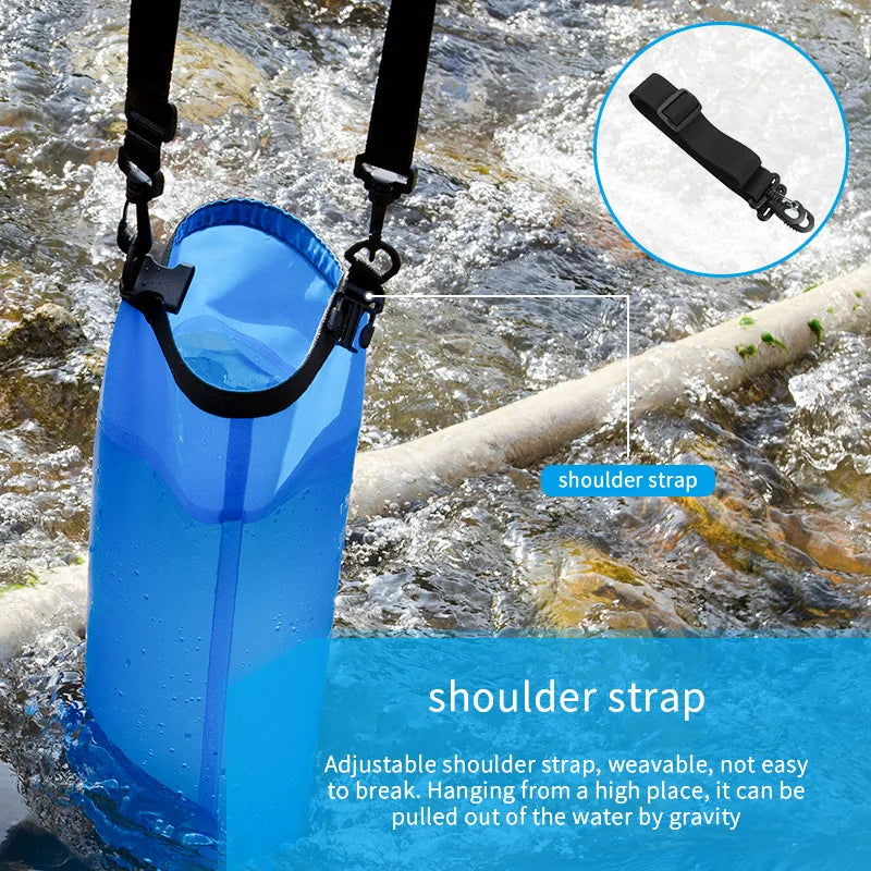 Blue gravity water filter bag placed in shallow stream
