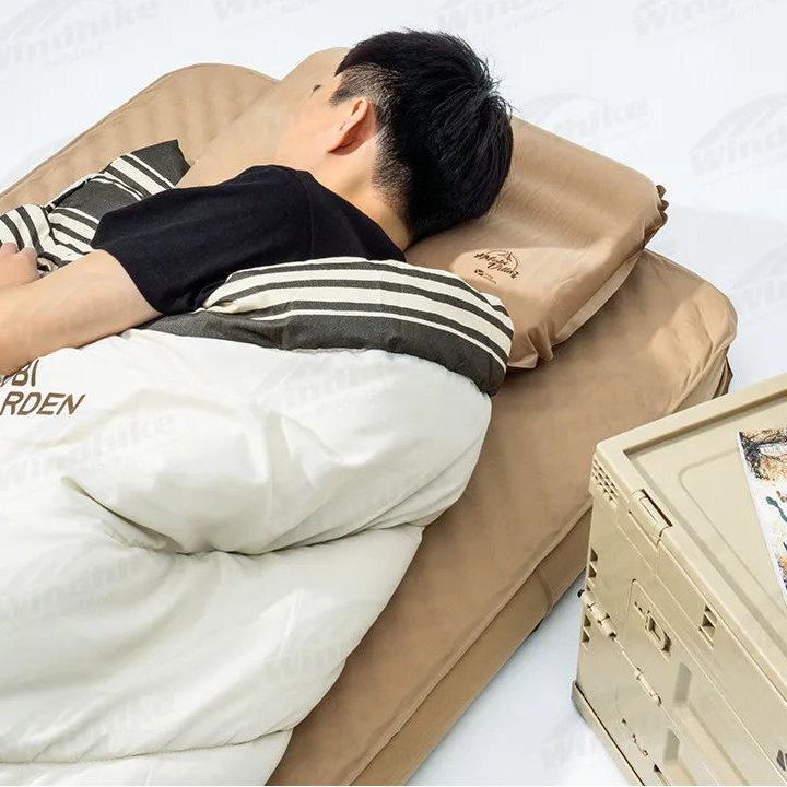 Person lying on inflatable camping pillow for side sleeping