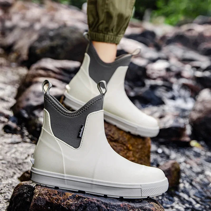 Men’s white ankle gumboots worn outdoors on rocky stream bed