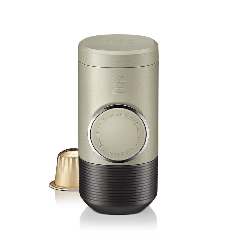 Compact Minipresso NS2 portable espresso maker with sleek beige body and black base ideal for travel or office use