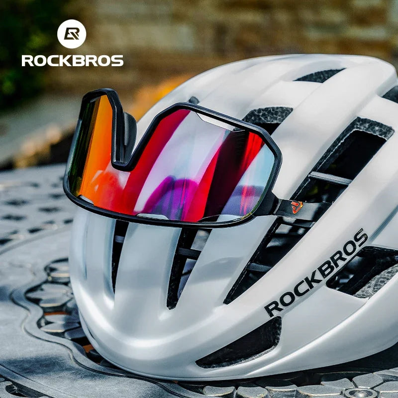 ROCKBROS SP351 sports sunglasses resting on helmet showing wraparound cycling fit