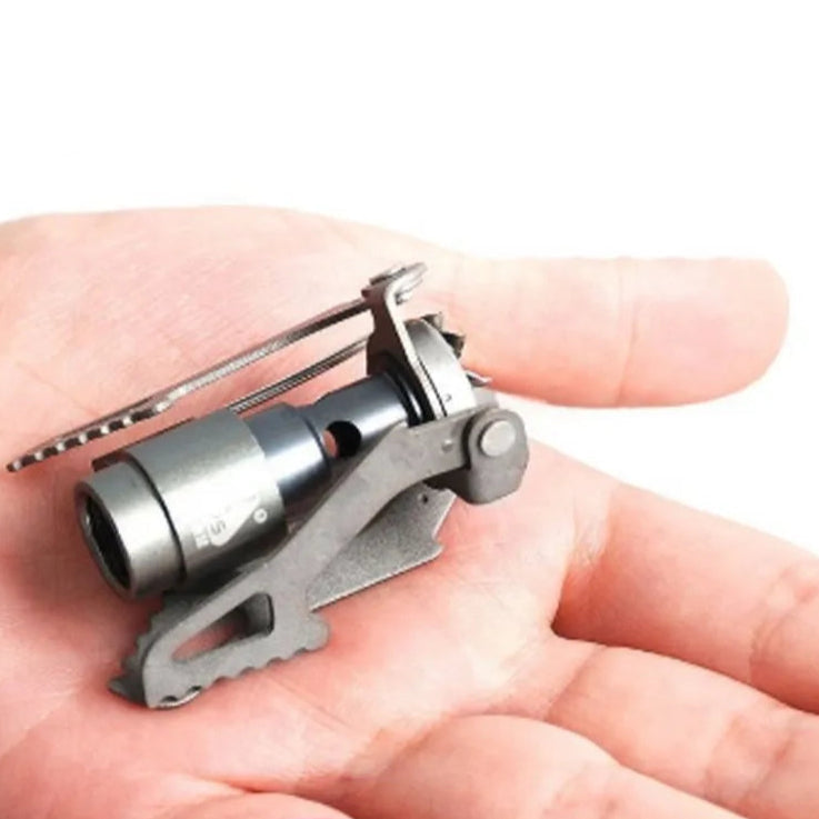 Ultra compact titanium mini camping stove resting on hand