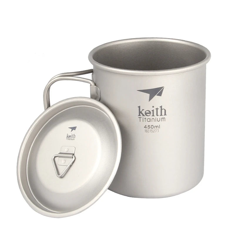 Titanium camping mug with lid placed beside cup