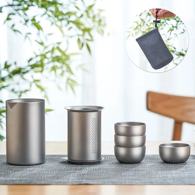 Titanium tea infuser set with brewing pot and matching cups on wooden table, perfect for home or outdoor use