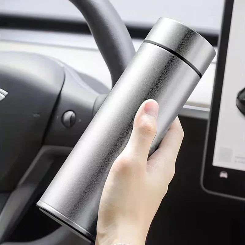 Titanium thermos cup held inside car interior