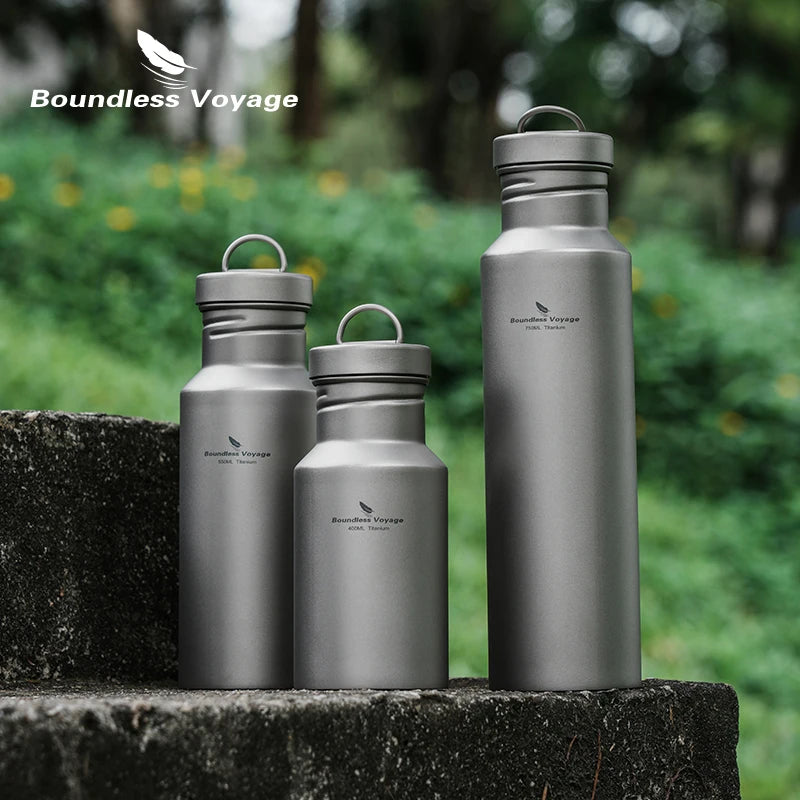 Titanium water bottles displayed outdoors on stone