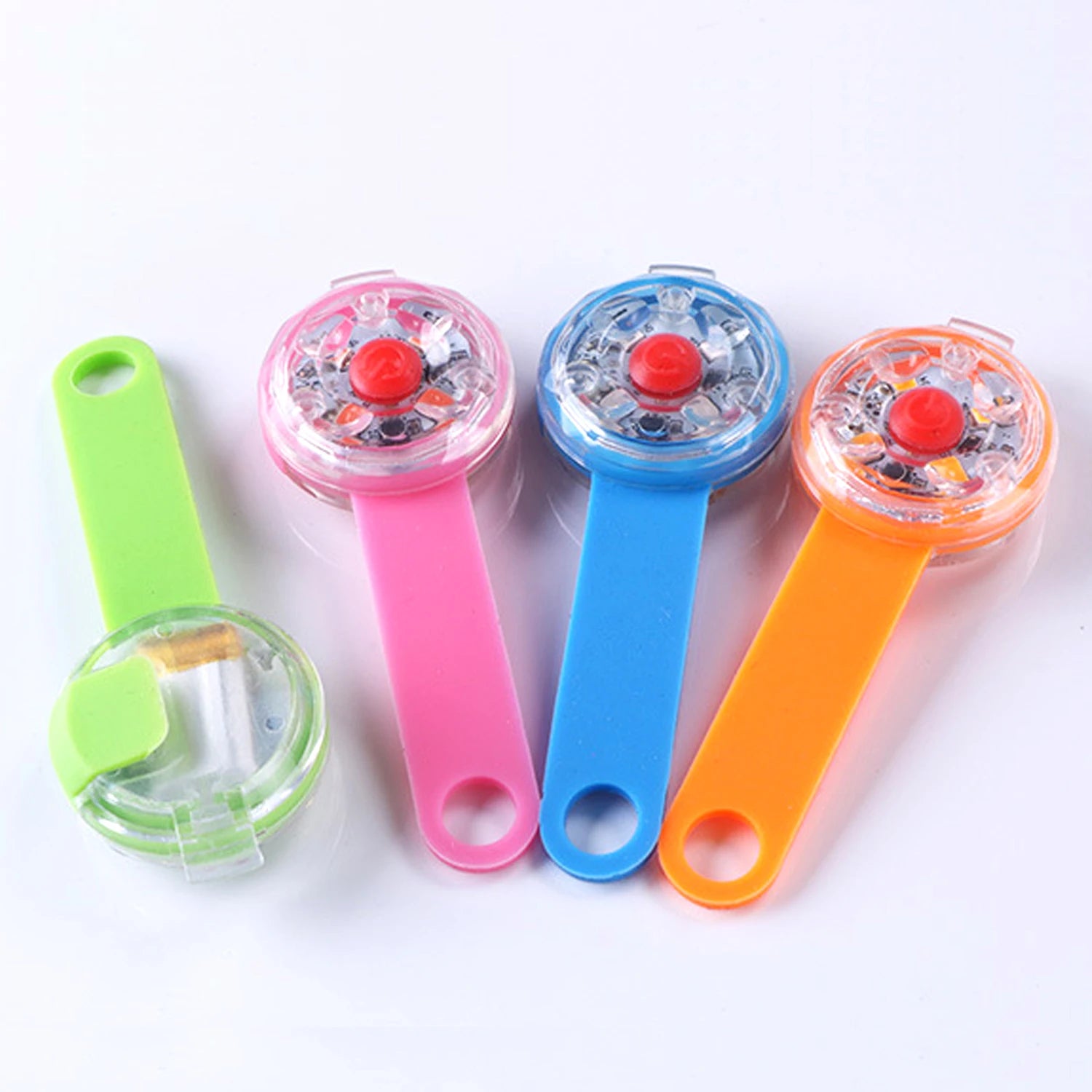 Assorted coloured LED dog collar lights on white background