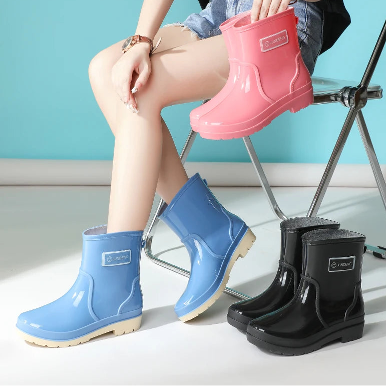 Women wearing blue and pink ankle gumboots while seated indoors