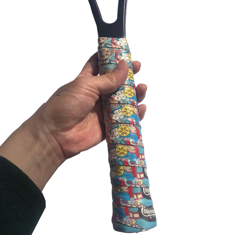 Hand wrapping colourful grip tape around tennis racket handle for secure, non-slip hold