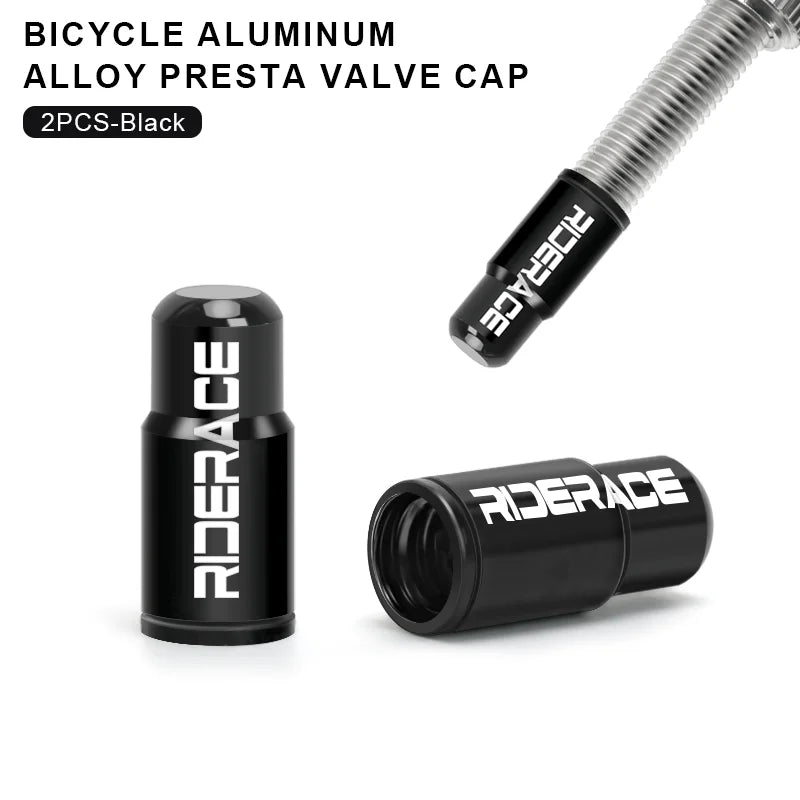 Pair black aluminium Presta valve caps fitted to bicycle valve stems