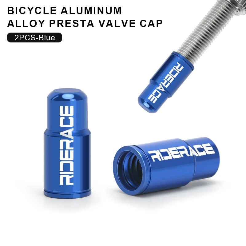 Pair of blue aluminium Presta valve caps fitted to bicycle valve stems