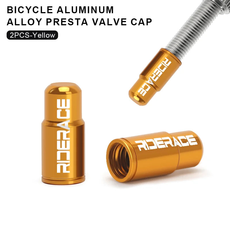 Pair of gold aluminium Presta valve caps fitted to bicycle valve stems