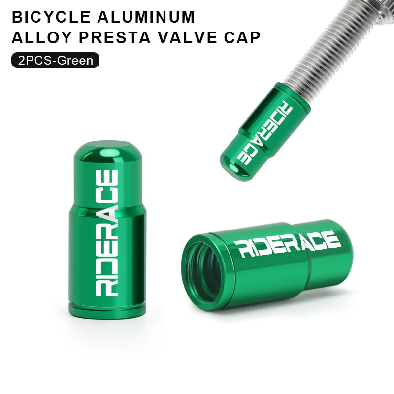 Pair of green aluminium Presta valve caps fitted to bicycle valve stems