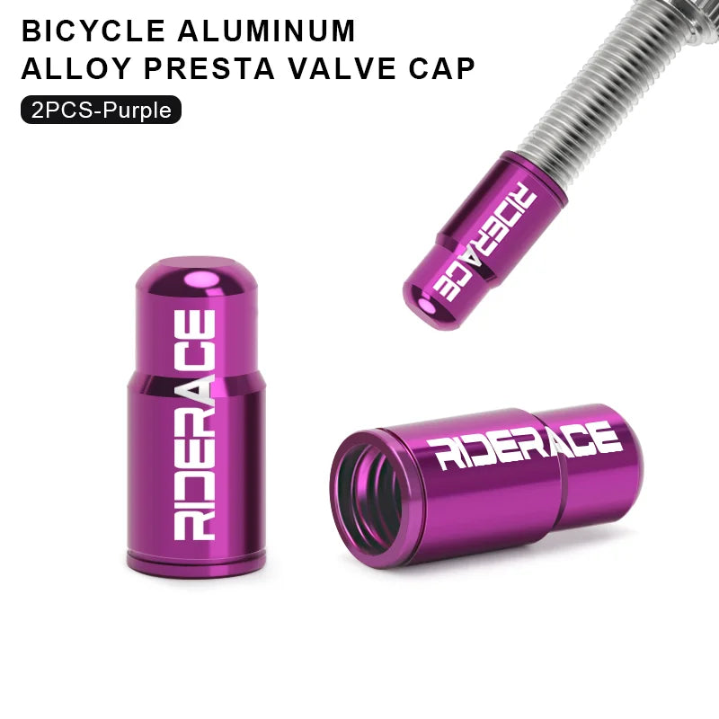 Pair of pink aluminium Presta valve caps fitted to bicycle valve stems