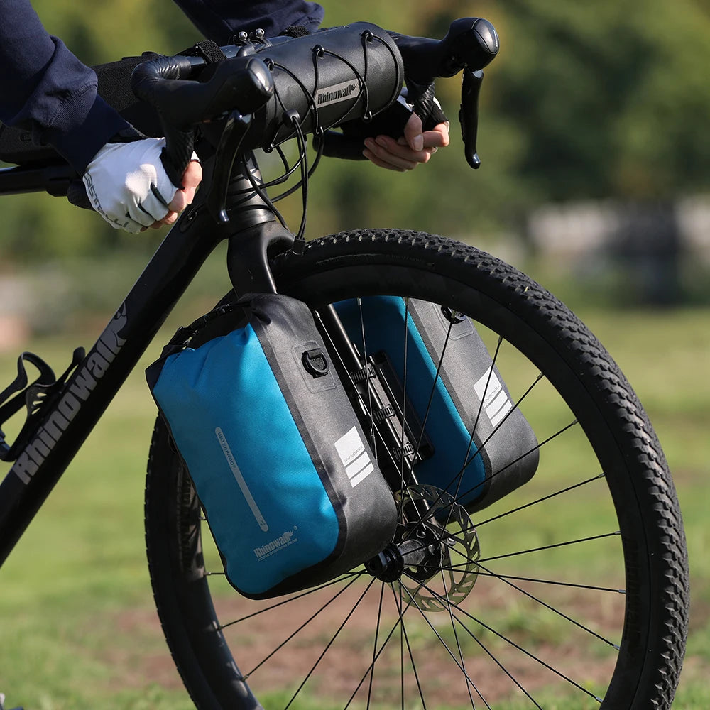 Blue fork mounted waterproof bike bag on gravel bike