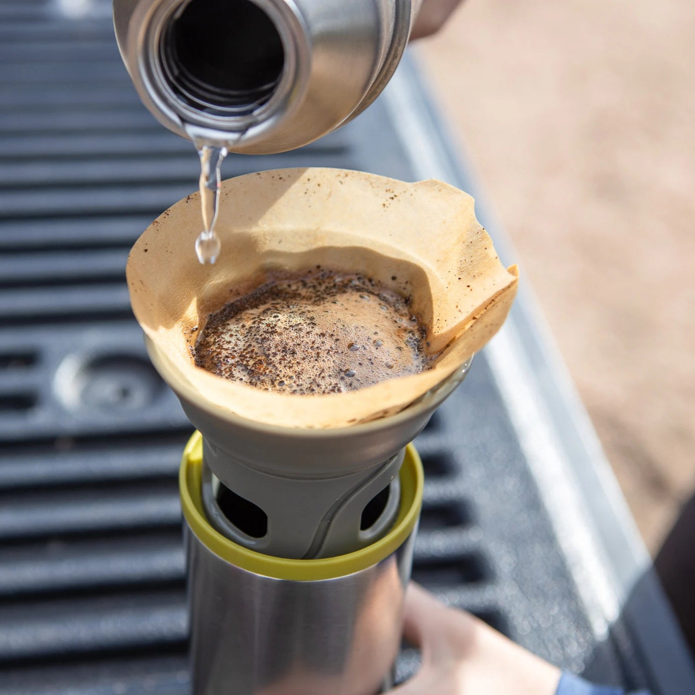 Fresh coffee being brewed outdoors with WACACO Cuppamoka portable pour-over coffee maker