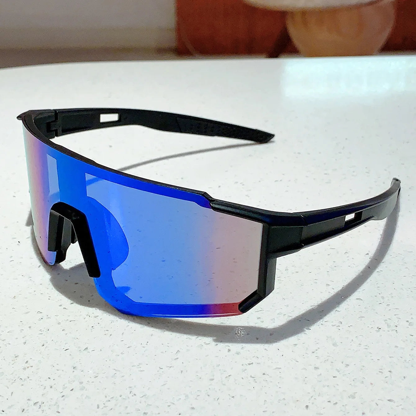BUYUTEEN blue-tinted sport goggles with black frame and UV400 mirrored lens protection