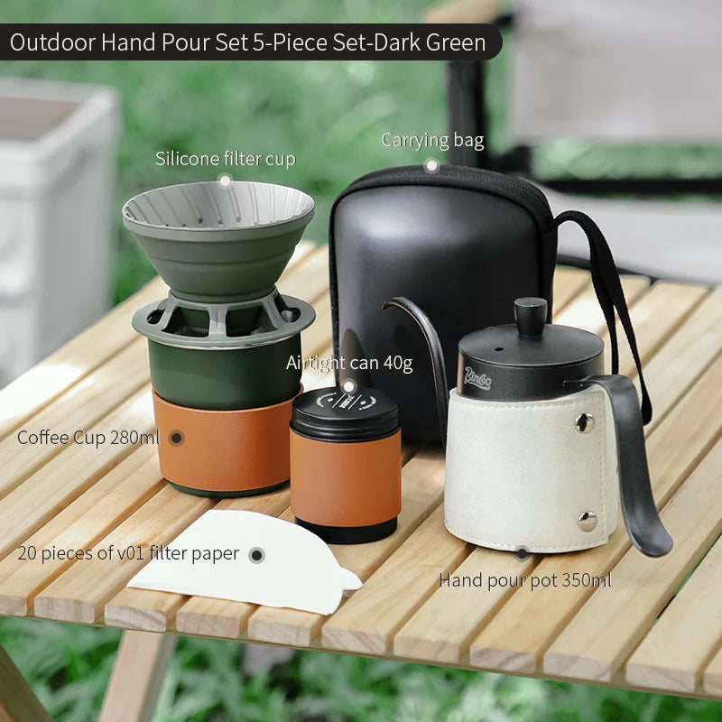 Outdoor coffee brewing kit with paper filters, kettle, and titanium accessories on wooden table