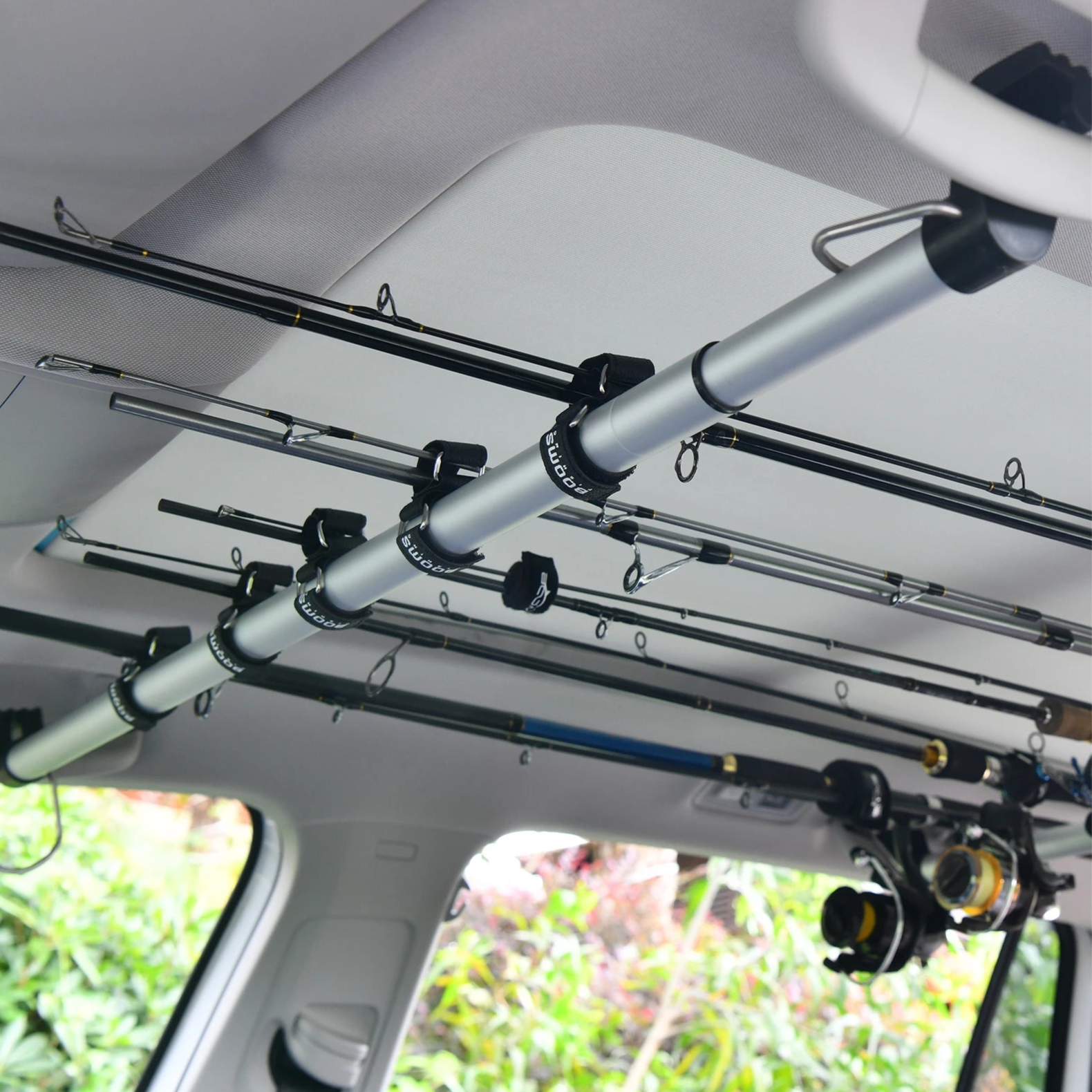 Adjustable fishing rod holder straps mounted inside car roof for secure transport and storage