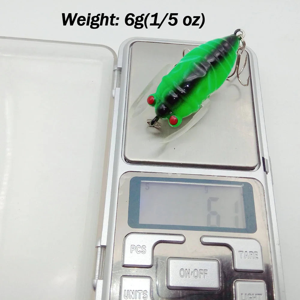 Cicada fishing lure placed on digital scale showing weight