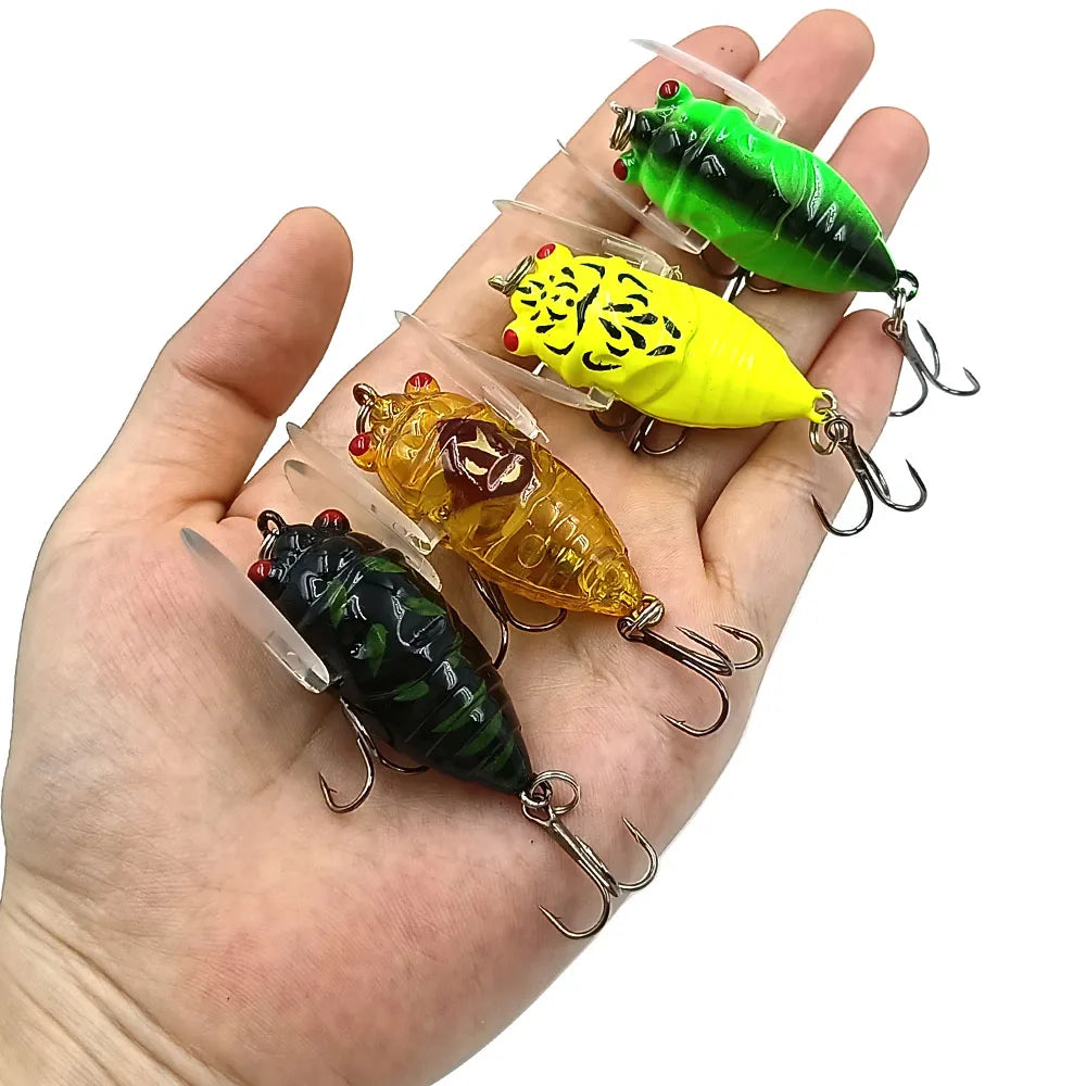 Hand holding multiple cicada-style fishing lures for size reference
