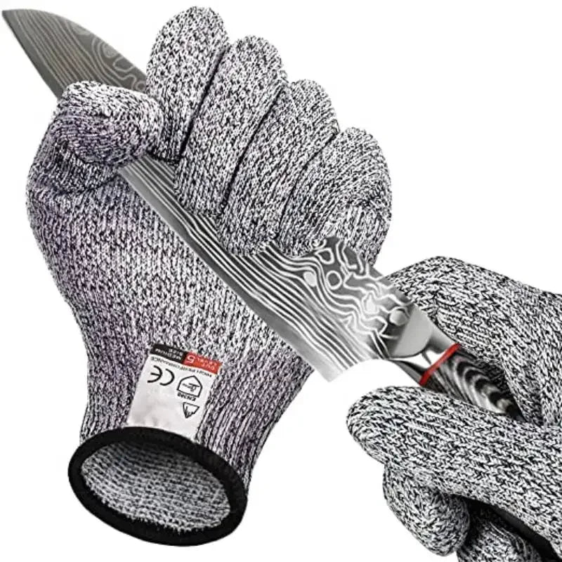 Cut resistant kitchen gloves holding sharp knife blade