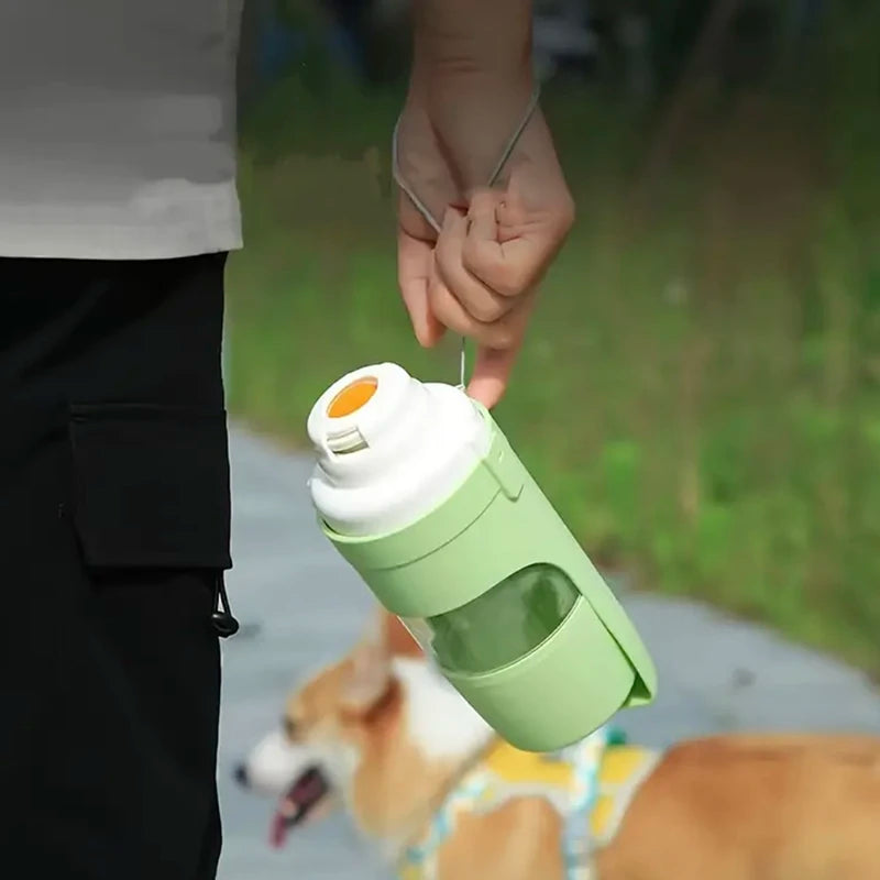 Person carrying green dog travel water bottle outdoors