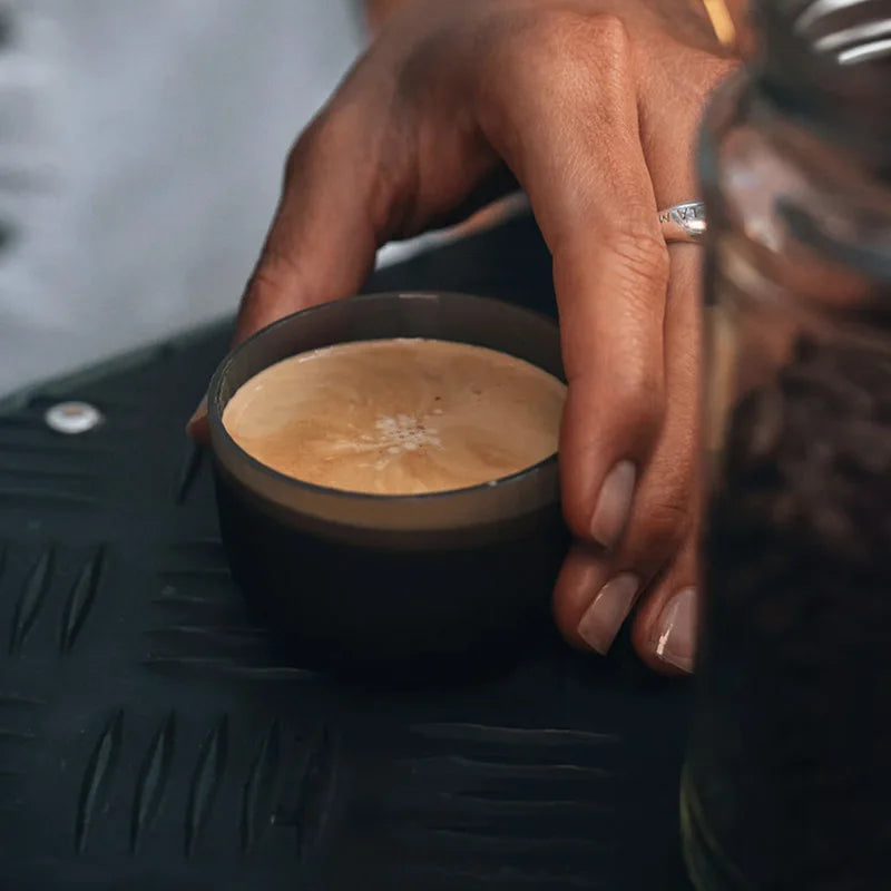 Espresso being poured from WACACO Minipresso GR2 into cup showing creamy golden crema