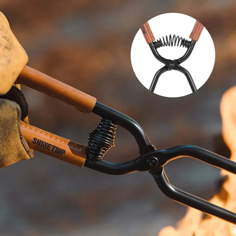 Close-up of fire poker jaws and wooden grip