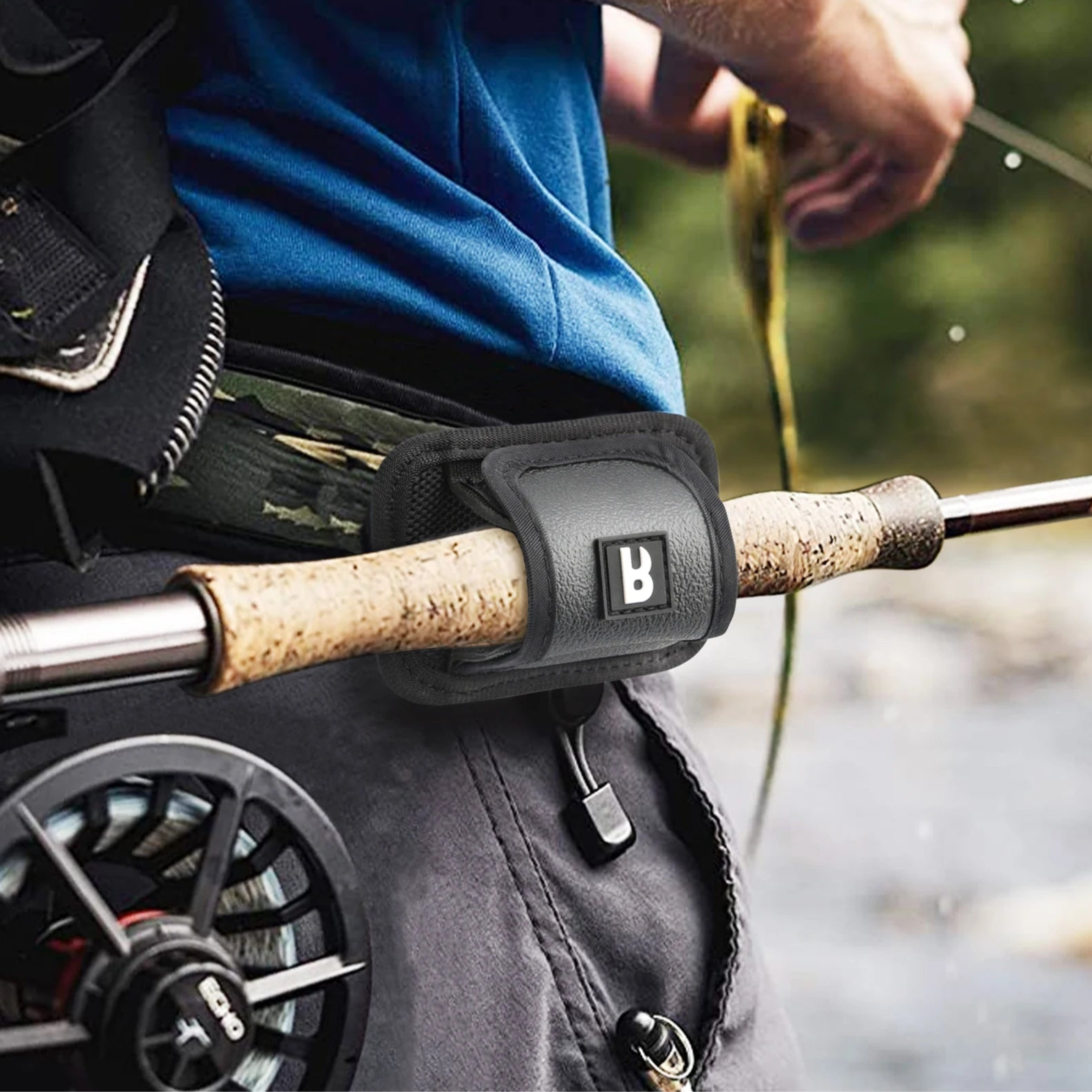 Angler using nylon fly rod holder clipped to waist belt for convenient hands-free fly fishing