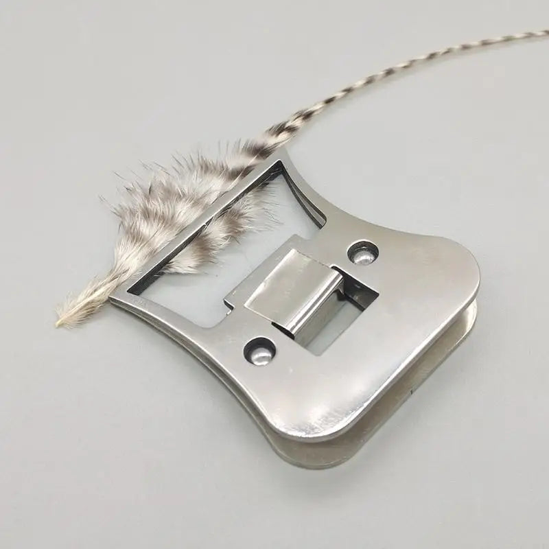 Fly tying hackle clamp securely gripping a feather during fly tying process