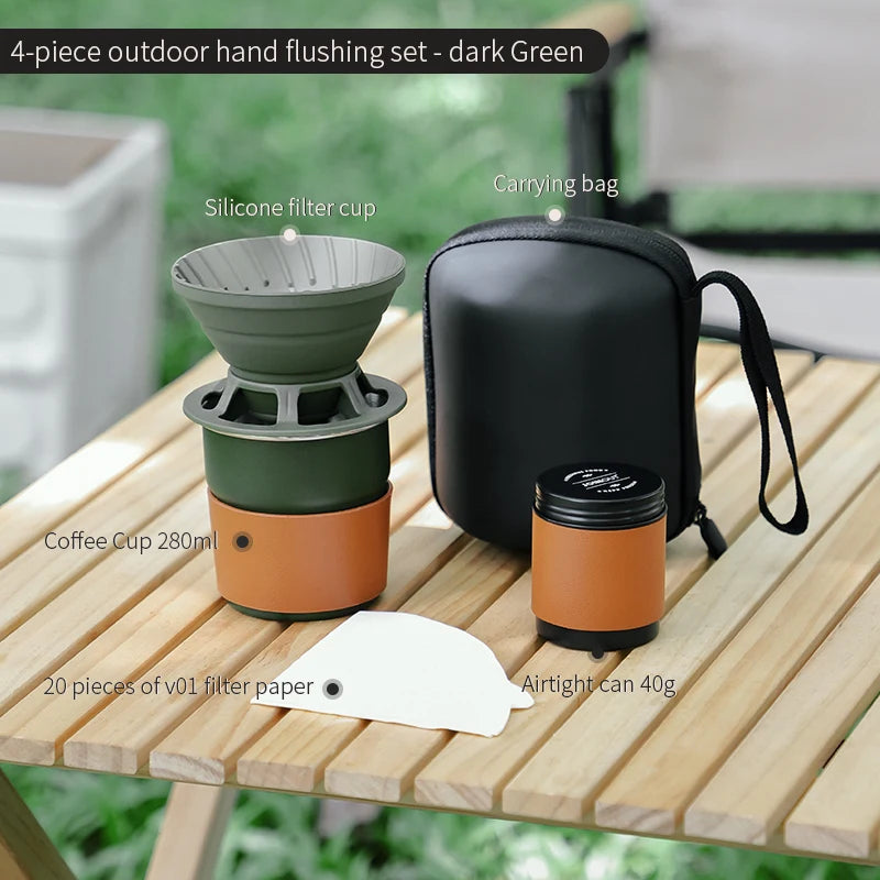 Four-piece dark green outdoor coffee brewing set with dripper, titanium cup, and compact kettle displayed on wooden camp table