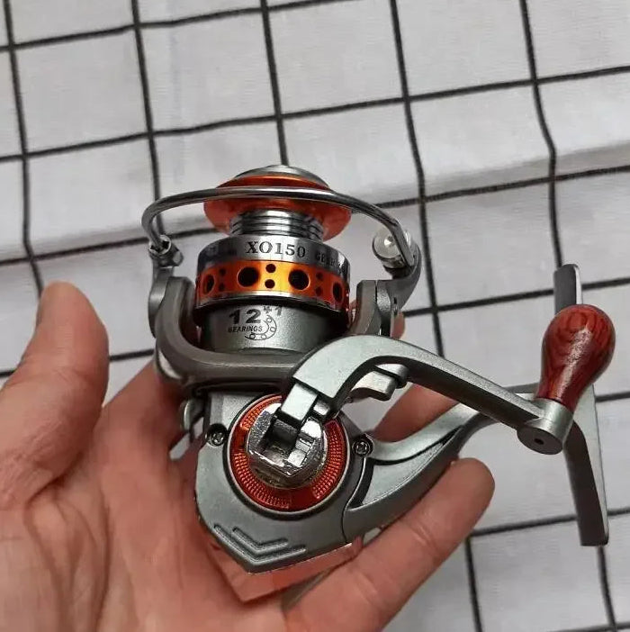 GT500 spinning reel placed on grid surface showing compact build and ergonomic handle grip
