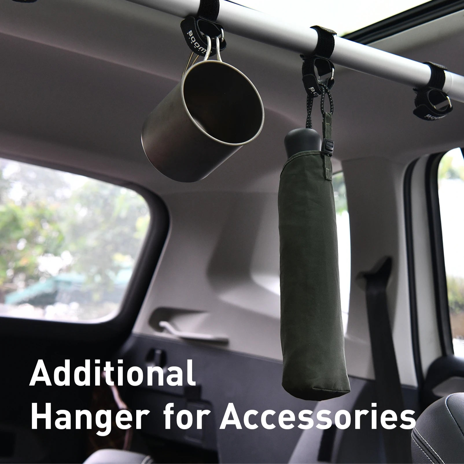 Fishing rods and accessories hanging securely from interior rod holder straps inside vehicle