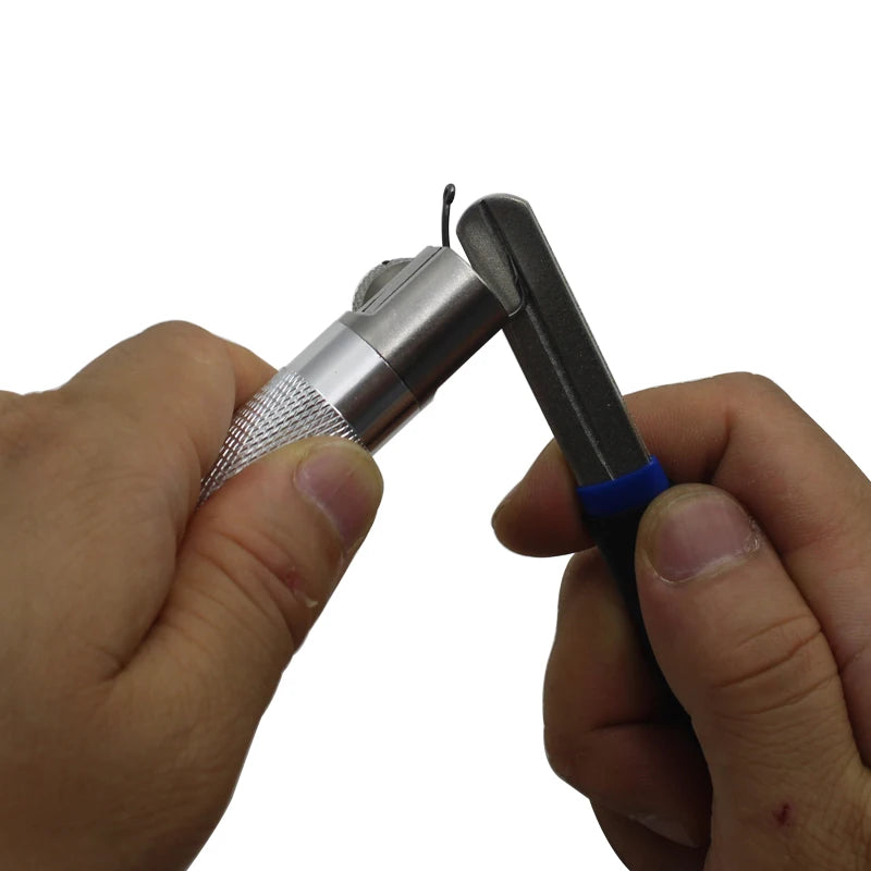 Hook sharpening kit in use showing grinder tool sharpening fishing hook held in clamp