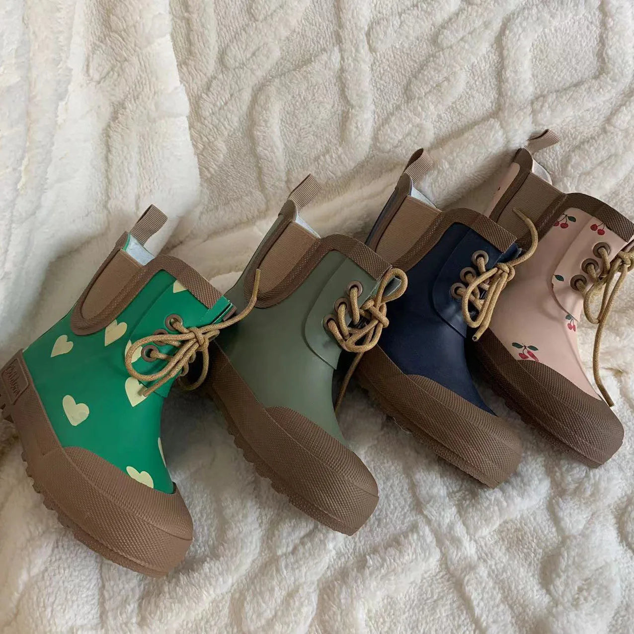Kids lace up rain boots laid out showing sole and lining details