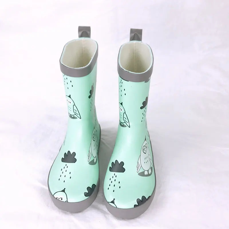 Green printed kids rain boots standing upright mid calf style