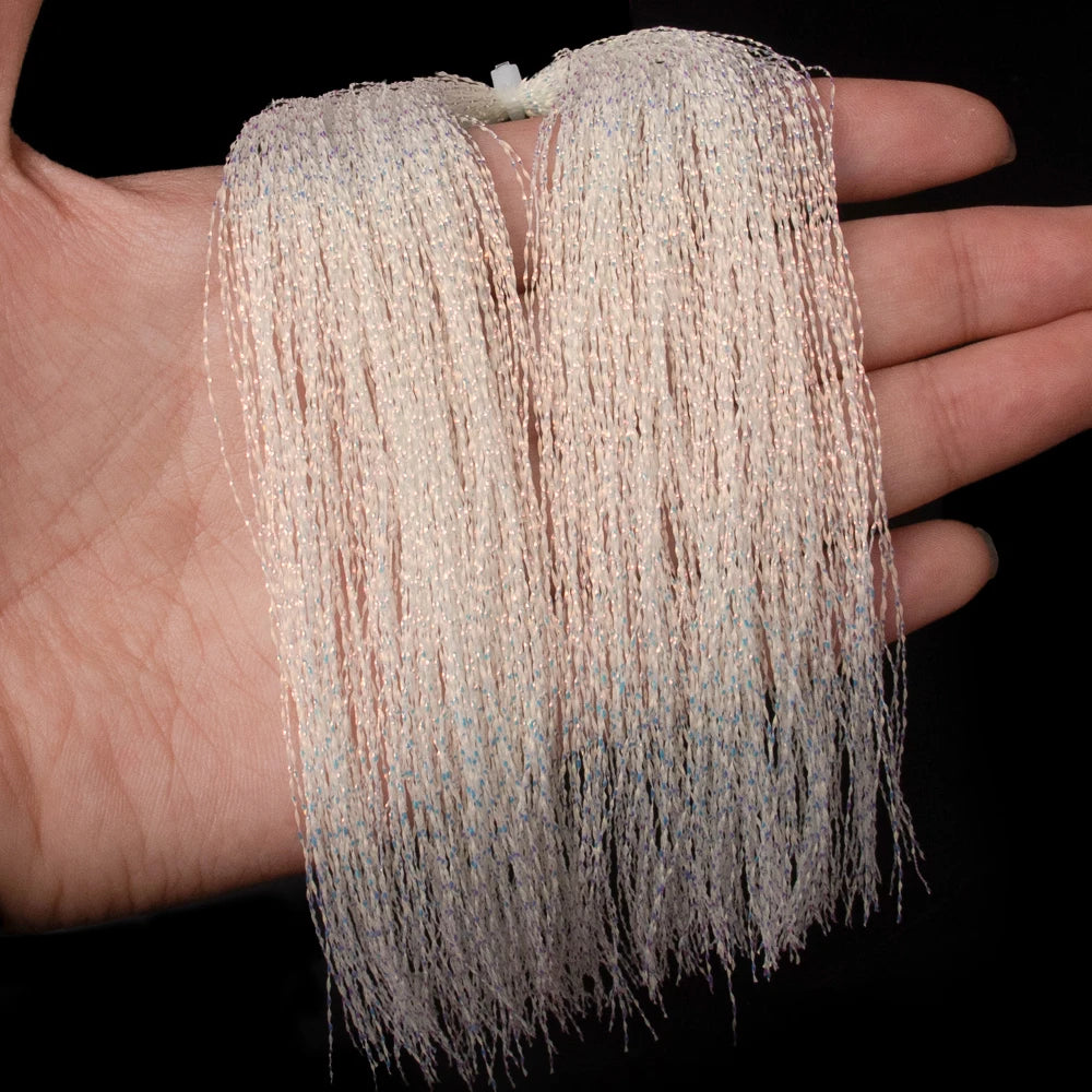 Close-up of luminous holographic flashabou tinsel held in hand showing texture and strand length