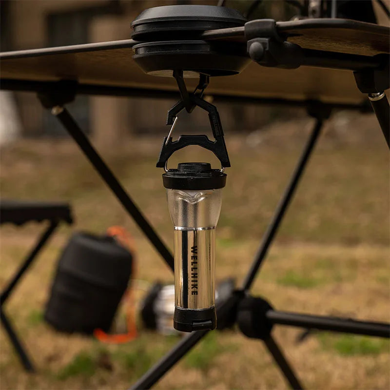 Magnetic hook mounted under camping table frame