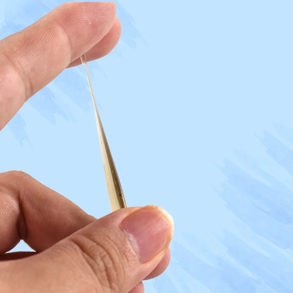 Micro soft worm lure bent between fingers showing flexibility