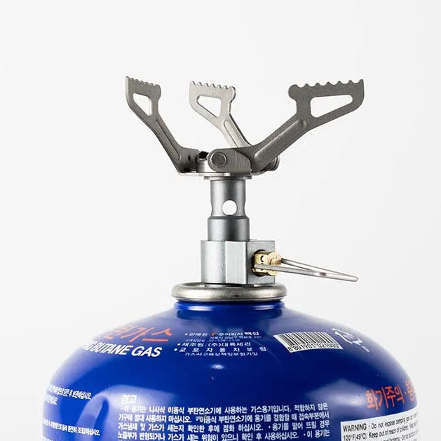 Compact titanium gas stove mounted on fuel canister